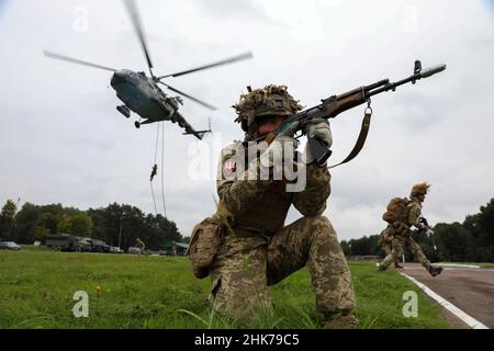 Lviv, Ukraine. 2nd. Februar 2022. Ukrainischer Bodentruppen-Soldat sorgt für Sicherheit während eines schnellen Seils eines ukrainischen Mi-8-Hubschraubers im Rahmen des Rapid Trident 2021 im Kampftrainingszentrum Yavoriv bei Yavoriv, Ukraine, 21. September 2021. Rapid Trident besteht aus 6.000 Soldaten aus 15 Partnerländern. Während der Übung sind gemeinsame Sprünge ukrainischer und amerikanischer Fallschirmjäger aus einem C-130-Flugzeug der US-Armee geplant. Stockfoto