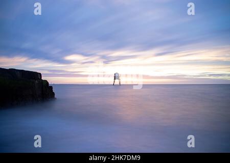 Langzeitbelichtungstechnik zur Erzeugung von Bewegung in den Wolken über dem Dovercourt Lighthouse bei Sonnenaufgang, Harwich & Dovercourt, North Essex, Großbritannien. Stockfoto