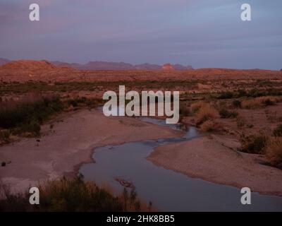 Der Santa Elena Canyon blickt zur goldenen Stunde mit dem Rio Grande River im Vordergrund und dem Chisos Mountain Range im Hintergrund. Foto Stockfoto