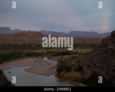 Santa Elena Canyon mit dem Rio Grande River im Vordergrund und dem Chisos Mountain Range im Hintergrund. Fotografiert im Big Bend National Park Stockfoto