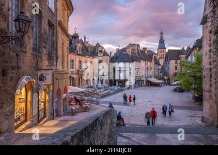 Sarlat Hauptplatz mit beleuchteten Geschäften und Sarlat Kathedrale bei Sonnenuntergang Sarlat Dordogne Frankreich Stockfoto