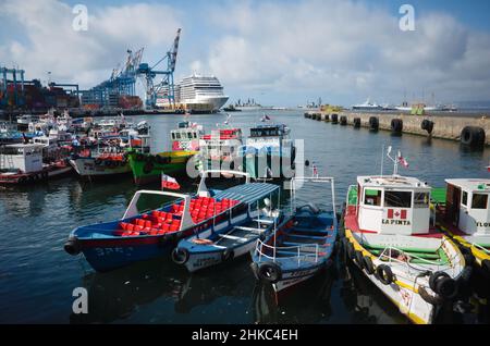 Valparaiso, Chile - Februar 2020: Boote und Runabouts liegen im Hafen von Valparaiso in der Nähe des Mole Muelle Prat. Viele Container im Seegandock Stockfoto