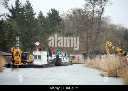 02. Februar 2022, Brandenburg, Oranienburg: Baumaschinen stehen auf der Baustelle der Friedensthaler Schleuse an der Havel. Nach Angaben der Stadt handelt es sich bei der aktuellen Rekonstruktion der Schleuse, die 1879 erbaut und 1959 stillgelegt wurde, um ein einzigartig umfangreiches Infrastrukturprojekt, das im vergangenen Jahr mit der Räumung von Sprengkörpern begonnen hatte. Nach dem Abriss soll bis Herbst 2023 eine komplett neue Schleuse gebaut werden. Damit wird der Hafen von Oranienburg mit den Ruppiner Gewässern verbunden, was insbesondere dem Wassertourismus zugute kommen soll. Foto: Soeren Sache/dpa-Zentralbild/ZB Stockfoto