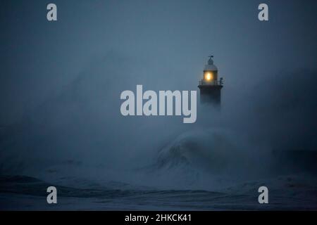 Die Sturmwinde des Sturms Arwen verursachen riesige Wellen, die den Leuchtturm und den Nordpier, die die Mündung des Tyne in Tynemouth, England, bewachen, schlagen Stockfoto