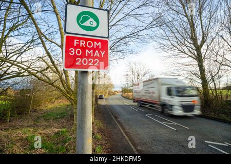 Greater Manchester Clean Air Zone Schild neben einer Straße, wie ein LKW fährt durch, England, Großbritannien Stockfoto