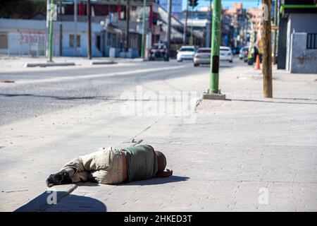 Ein obdachloses Kind, das auf dem Bürgersteig in der Stadt Puerto Penasco, Sonora, Mexiko, liegt. Stockfoto