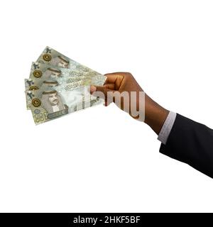 Schwarze Hand mit 3D gerenderten 20 Bahrain-Dinar-Noten isoliert auf weißem Hintergrund Stockfoto