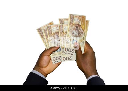 Schwarze Hände im Anzug mit 3D gerenderten Zloty-Noten Stockfoto