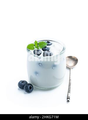 Weißer cremiger Joghurt mit frischer Heidelbeere in einem kleinen Glas auf Weiß isoliert Stockfoto