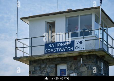 Ein Wächter der National Coastwatch Institution hält vom Bahnhof in Porth Dinllaen, Wales, einen Blick über die Caernarfon Bay Stockfoto