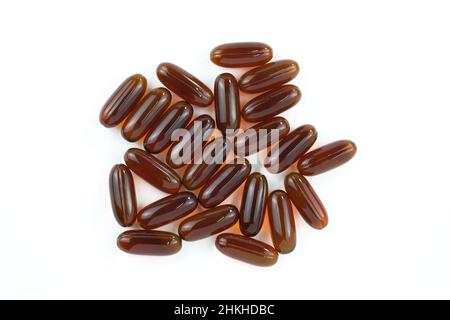 Sonnenblumenlecithin in Kapseln auf weißem Hintergrund. Lecithin in braunen Kapseln Draufsicht. Nahrungsergänzungsmittel aus nächster Nähe. Stockfoto