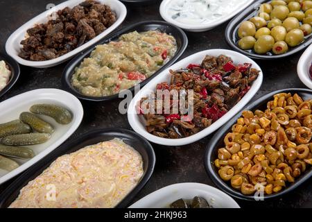 Mediterranes Vorspeisenkonzept. Traditionelle türkische Küche. Vorspeise aus dem Nahen Osten mit Rote Beete, Oliven, Hummus, gefüllten Paprika, Gurken, Stuffe Stockfoto