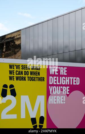 Wir freuen uns, dass Sie hier sind und 2 Meter am Google Headquarter Site Fence neben der U-Bahn-Station King's Cross in London, Großbritannien, unterschreiben Stockfoto