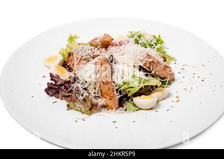 Warmer Salat mit gegrilltem Lachs und Wachteleiern. Isoliert auf weißem Hintergrund. Stockfoto