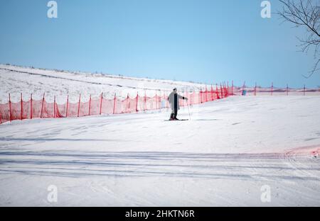 ZHANGJIAKOU, CHINA - 5. FEBRUAR 2022 - Touristen fahren im touristischen Kulunnur-Gebiet in Zhangjiakou, der nordchinesischen Provinz Hebei, am 5. Februar 2022 Ski. Stockfoto