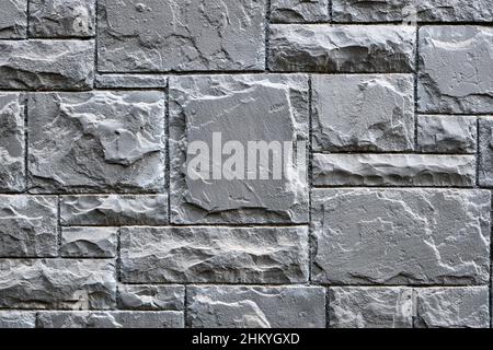 Hintergrund von einer Wand aus grauen Granitsteinen Stockfoto