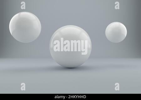 3D Rendering von mehreren großen reflektierten weißen Kugeln in einem weißen Studio Stockfoto