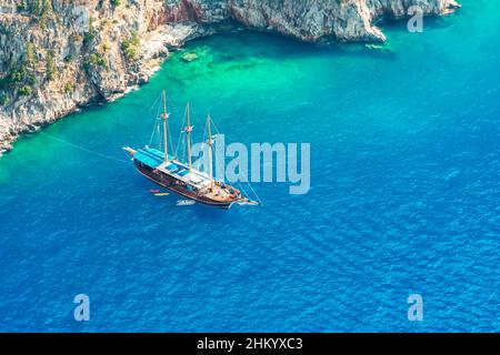 Luftdrohne Ansicht von schönen hölzernen Segelboot in tiefblauem Meer von Butterfly Valley, Fethiye, Türkei Stockfoto
