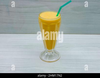 Mango Lassi in Glas auf grauem Hintergrund Draufsicht Stockfoto