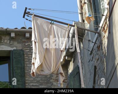 Wäschetrocknung an einem Fenster in Venedig in Italien Stockfoto