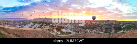 Panoramablick auf die Heißluftballons fliegen Tour über Berge Landschaft Frühling Sonnenreis Kappadokien, Goreme Open Air Museum National Park, Türkei na Stockfoto