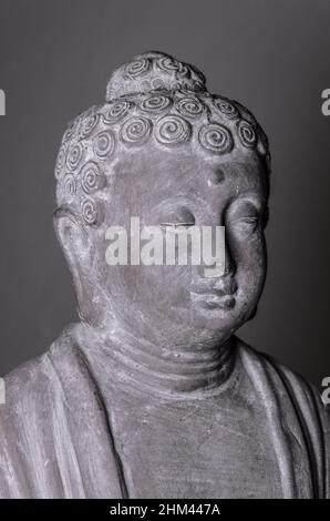 Siddharha Gautama Buddha Statue aus grauem Stein als Innendekoration, Nahaufnahme Portrait Ansicht Stockfoto