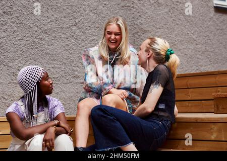 Junge Freunde sitzen auf der Treppe Stockfoto