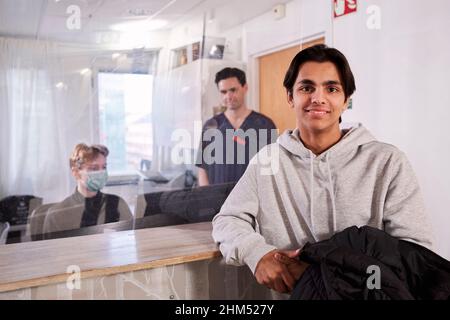 Porträt eines männlichen Patienten an der Rezeption in der Arztpraxis Stockfoto