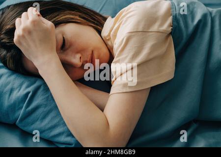 Traurige junge Frau liegt im Bett mit einem depressiven Zustand. Stockfoto