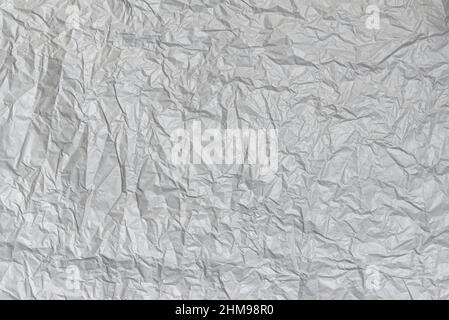 Zerknitterte graue Papierstruktur. Abstrakter leerer Hintergrund für Design Stockfoto