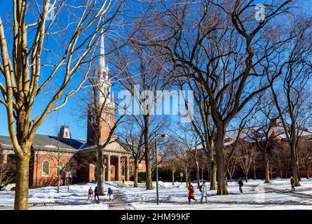 Cambridge, Massachusetts, USA - 6. Februar 2022: Studenten gehen an einem Wintertag in Harvard Yard. Die Memorial Church der Harvard University. Stockfoto