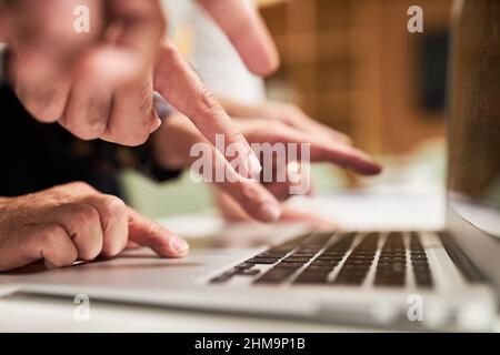 Der Finger zeigt auf die Tastatur des Laptops, die das Internet und die Zukunft symbolisiert Stockfoto