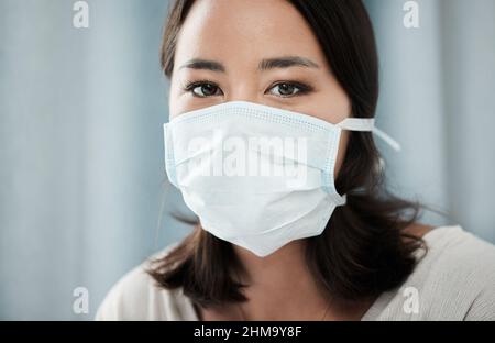 Hinter diesen Masken sind schöne starke Seelen. Nahaufnahme einer schönen jungen Frau, die eine Maske trägt. Stockfoto