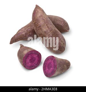 Ganze und halbierte frische violette Süßkartoffeln isoliert auf weißem Hintergrund Stockfoto