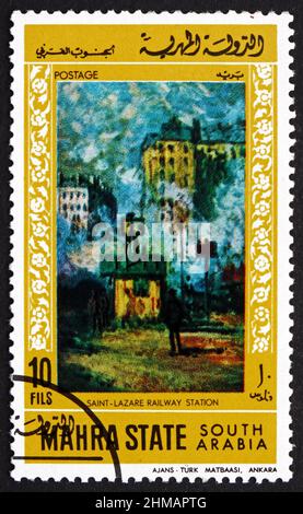 STAAT MAHRA - UM 1968: Eine im Staat Mahra gedruckte Briefmarke zeigt den Bahnhof Saint-Lazare, Gemälde von Claude Monet, um 1968 Stockfoto