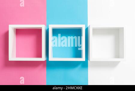 Einfaches Design mit leerem blauen Rahmen isoliert auf rosa und blau pastellfarbenem Hintergrund. Draufsicht, flach liegend, Kopierraum, Modell. Stockfoto