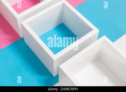 Einfaches Design mit leerem blauen Rahmen isoliert auf rosa und blau pastellfarbenem Hintergrund. Draufsicht, flach liegend, Kopierraum, Modell. Stockfoto