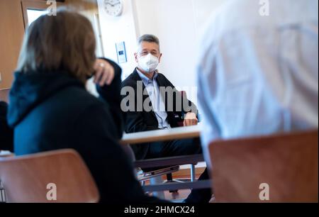 München, Deutschland. 09th. Februar 2022. Der bayerische Bildungsminister Michael Piazolo (M, Freie Wähler) spricht mit Schülern der Klassen 5-10 der Marieluise-Fleißer-Realschule über ihre Erfahrungen in Zeiten der Pandemie. Quelle: Sven Hoppe/dpa/Alamy Live News Stockfoto