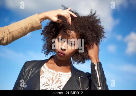 Stylistin bereitet eine schöne schwarze weibliche Modell für ein Fotoshooting Stockfoto