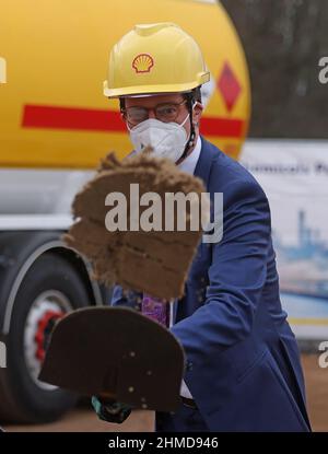 09. Februar 2022, Nordrhein-Westfalen, Köln: Hendrik Wüst (CDU), Ministerpräsident von Nordrhein-Westfalen, wirft beim Baubeginn einer CO2-neutralen bio-verflüssigten Erdgasanlage (Bio-LNG) auf dem Raffineriestandort Shell eine Sandschaufel. Die Anlage wird voraussichtlich ab Mitte 2023 rund 100.000 Tonnen Bio-LNG pro Jahr für den Schwerlasttransport produzieren. Foto: Oliver Berg/dpa Stockfoto