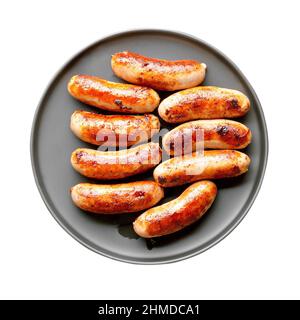 Gebratene Wurst auf isoliertem weißem Hintergrund. Draufsicht, flach liegend Stockfoto