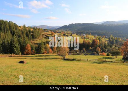 Majestätische Landschaft mit ländlicher Wiese in den herbstlichen Karpaten, Ukraine Stockfoto