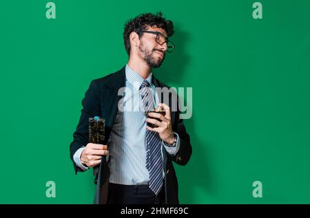 Eleganter Geschäftsmann, der sich parfümiert und seine Haare kämmt, Geschäftsmann malt und parfümiert sich isoliert auf grünem Hintergrund Stockfoto