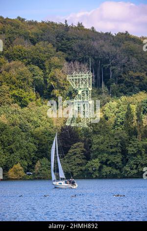 Essen, Nordrhein-Westfalen, Deutschland - Baldeneysee. Segelboot vor dem Förderrahmen der ehemaligen Zeche Carl Funke. Die Zeche Carl Funke war ein Kohlebergwerk in Essen-Heisingen am Nordufer des Baldeney-Sees. Stockfoto