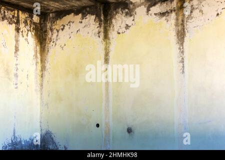 Hintergrund Betonwand, Spuren von Verwitterung, abgenutzte Wand beschädigt Farbe alte Farbe. Reste von alter Farbe auf der lackierten Betonoberfläche. Grungy Degru Stockfoto