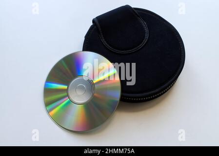 Compact Disc und ein schwarzes Gehäuse auf weißem Hintergrund. Technologie aus dem Jahr 90s. Stockfoto