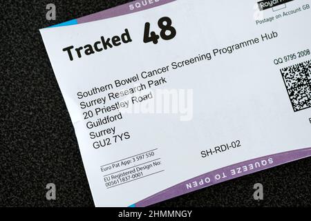 Ein Rückumschlag-Paket für das britische Testkit für das Screening von Darmkrebs nach NHS. Bekannt als fäkaler immunochemischer Test oder FIT zur Entnahme einer Poo-Probe Stockfoto
