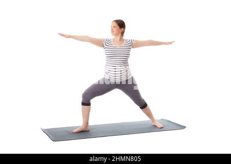 Schwangere beim Yoga Asana Virabhadrasana 2 Stockfoto