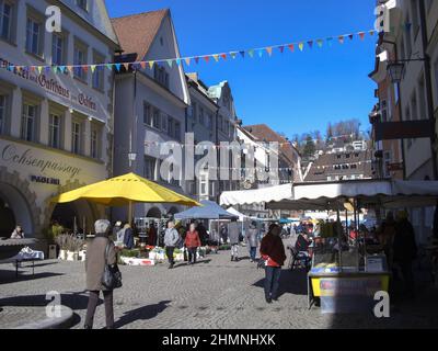 Feldkirch, Österreich, 26. Februar, 2019 Menschen wandern an einem sonnigen Tag durch die Altstadt mit Marktständen Stockfoto