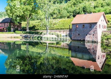 Mespelbrunn, Bayern, Deutschland -07 25 2018: Die Schlossgebäude spiegeln sich im Sommer im Wasserteich Stockfoto